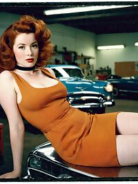 Woman in a bright orange 1950s dress with auburn hair repairs cars at the local garage